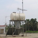 water tanks with solar panels below