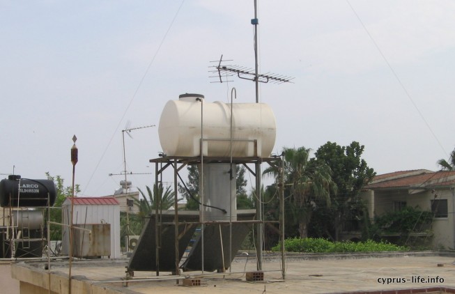 water tanks with solar panels below
